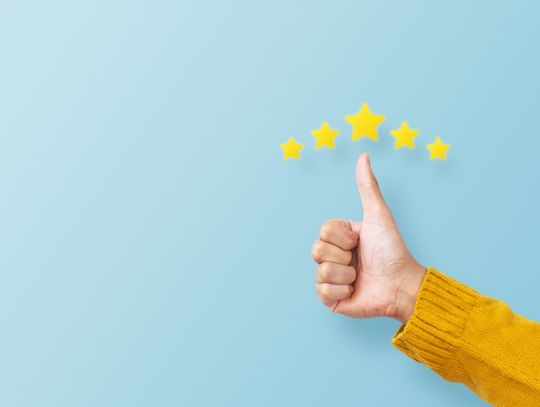 Five yellow stars above a hand making the thumbs up gesture against a light blue backdrop.