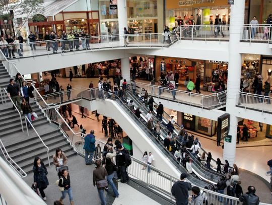 A bustling three-story mall, teeming with throngs of customers hurrying in every direction during the peak hours of the day.