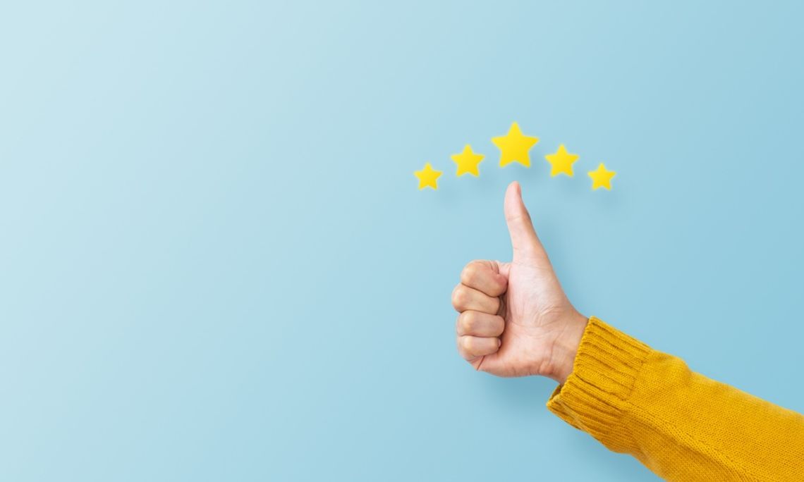 Five yellow stars above a hand making the thumbs up gesture against a light blue backdrop.