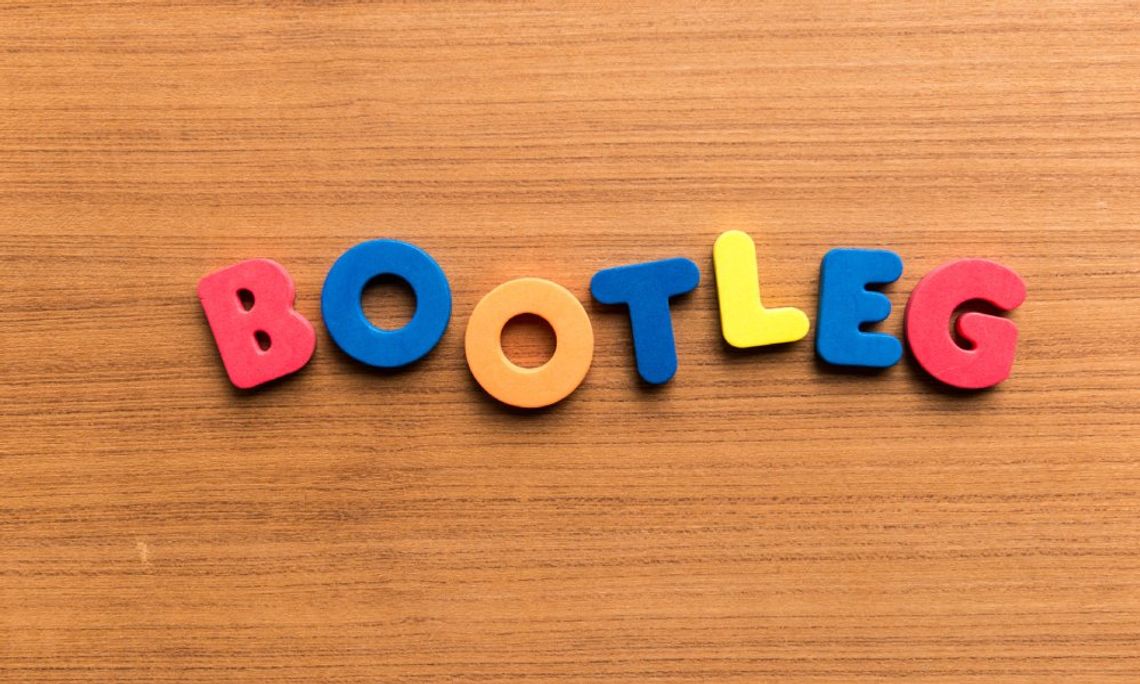 The word "BOOTLEG" spelled out in colorful foam letters—red, blue, orange, and yellow—on a wooden surface.