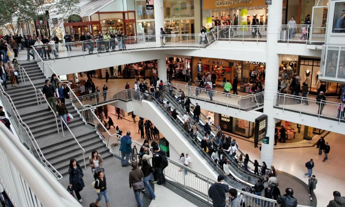 A bustling three-story mall, teeming with throngs of customers hurrying in every direction during the peak hours of the day.