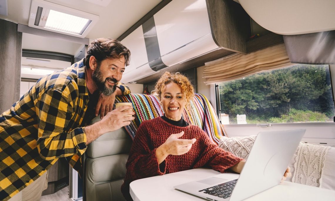Common Sources of Unpleasant Odors Inside an RV A man and a woman are sitting inside an RV. The woman is using a laptop and gesturing to the screen.