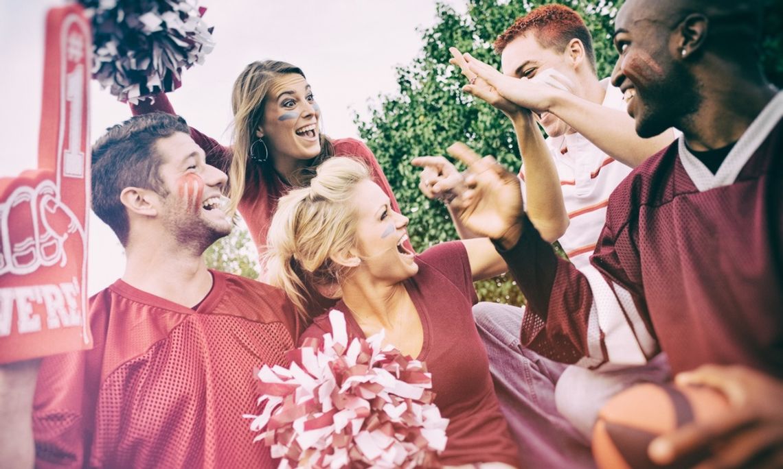 Game Day Style: Tailgating Looks That Score A group of college students is excited for the football game, all wearing red to show their school spirit.
