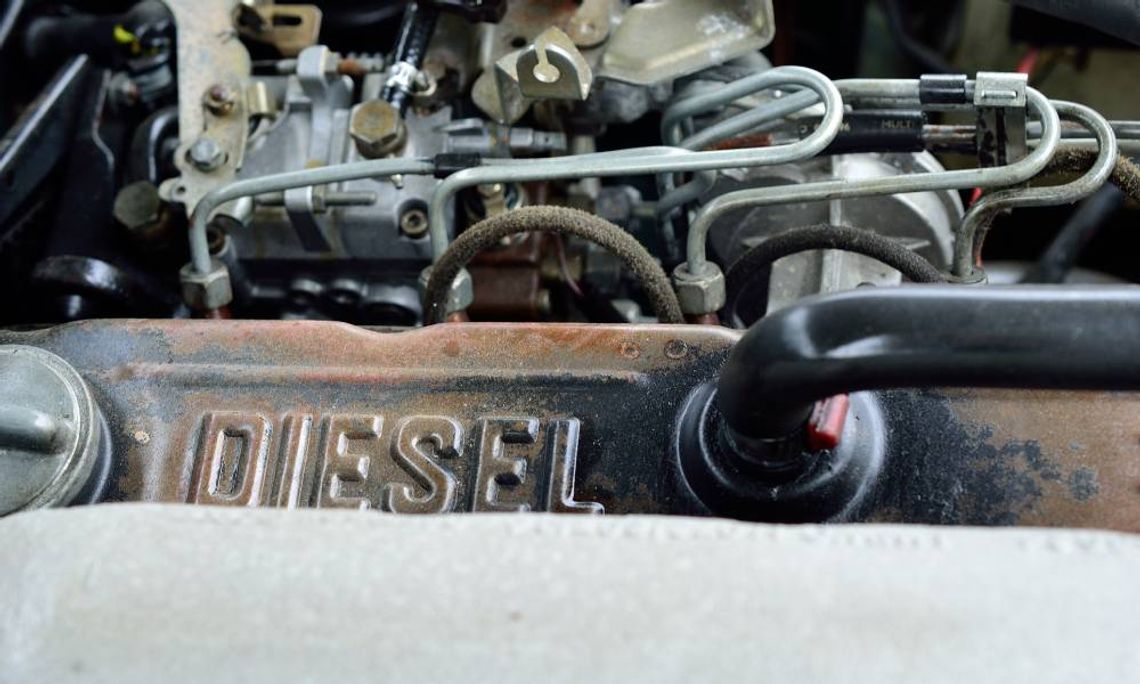 Close-up of a rugged steel and iron diesel engine. The word "DIESEL" is stamped on the top of the engine.