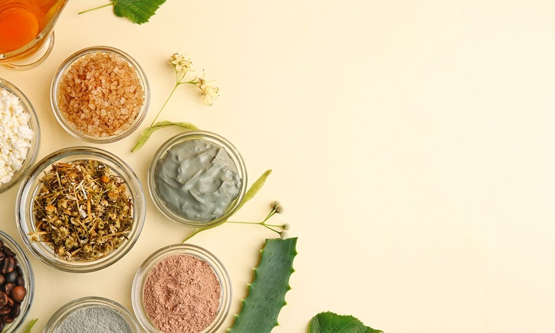 Simple Kitchen Tips for Preserving Natural Ingredients Top view of cosmetic ingredients like clay masks, dried herbs, bath salts, and oil arranged on neutral surface.